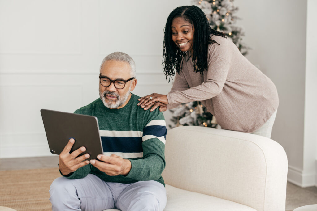 Adult couple using tablet device to view Maestro Patient Reports.